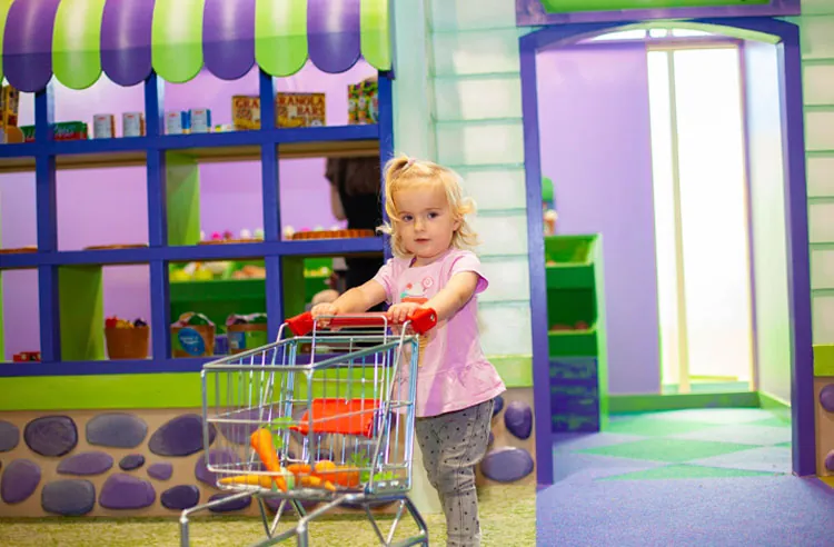 A child at the play house door at Fun Street