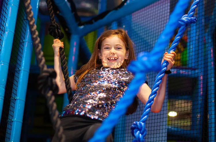 A kid playing in the play house at Fun Street