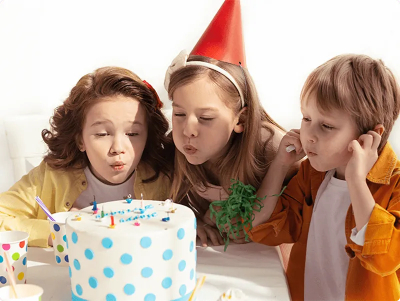 Children blowing out birthday candles at Fun Street soft play in Glasgow