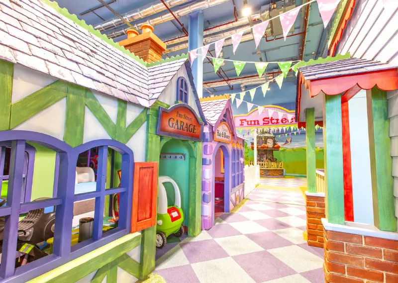 Storybook street of themed playhouses at Fun Street soft play, Glasgow